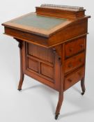 An Edwardian walnut davenport, set a top compartment with hinged stationery rack,