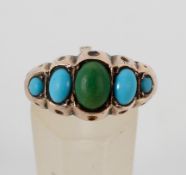 A yellow metal half hoop ring set with five graduated cabochon cut turquoise.