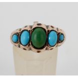 A yellow metal half hoop ring set with five graduated cabochon cut turquoise.