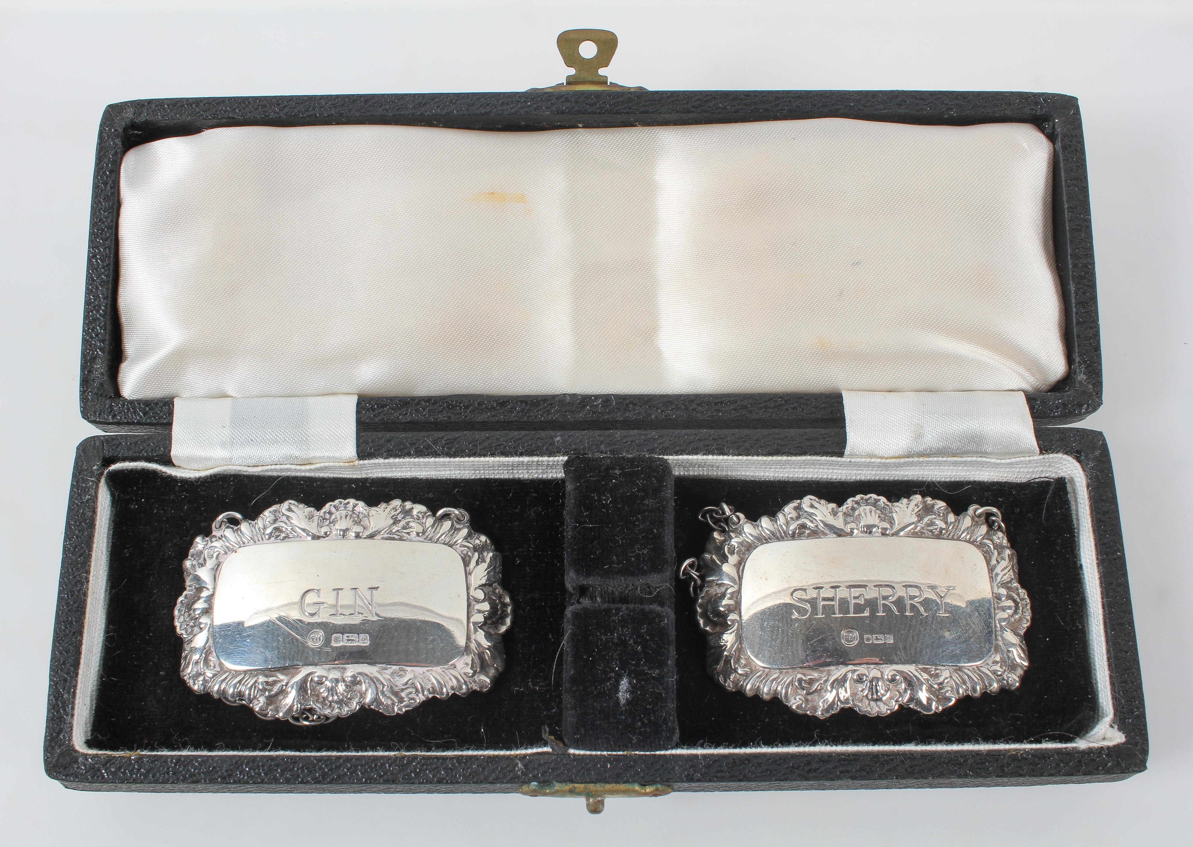 A pair of silver decanter labels "Gin" and "Sherry" in original case,