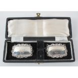 A pair of silver decanter labels "Gin" and "Sherry" in original case,