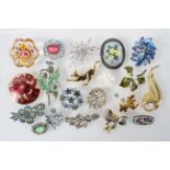 A collection of twenty costume brooches of variable deigns.