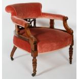 A 19th century upholstered mahogany tub chair, carved decoration, turned supports with castors,