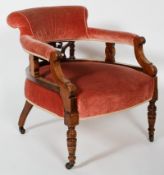 A 19th century upholstered mahogany tub chair, carved decoration, turned supports with castors,