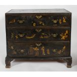 A George III Japanned black and gilt chest with three drawers with brass bat wing shaped handles