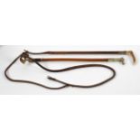 Two vintage hunting whips, comprising : a Swan silver mounted carved horn handled leather whip,