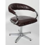 A 1970's vintage swivel desk chair, with tubular chromed frame and faux leather upholstery,