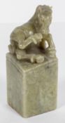 A Chinese green hard stone seal with horse finial,