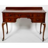 A Victorian mahogany dressing table, with an arrangement of five drawers, on cabriole legs,