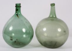 Two early 20th century Carbuoys, of green tint and with globular body and kick-in base,