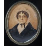 An early 19th century miniature of an elderly lady, in ebonised frame,