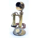 A reproduction brass telephone the dial labelled " Centenary of the telephone 1876-1976",