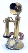A reproduction brass telephone the dial labelled " Centenary of the telephone 1876-1976",
