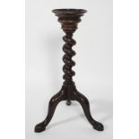 A George III style spiral pedestal torchere stand, raised upon tripod supports,