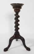 A George III style spiral pedestal torchere stand, raised upon tripod supports,