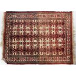 An Afghan rug, the wavy field with columns of stepped guls enclosed by narrow borders,