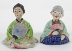 A pair of Chinese stoneware nodding figures of a boy and girl with fans,