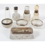 A collection of assorted silver topped and mounted glass items, including open salts,
