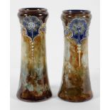 A pair of Royal Doulton stoneware vases, of waisted form, with slip trailed floral decoration,