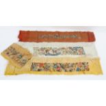 Four early 20th century embroidered silk panels, on yellow, ivory and pale red silk,