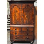 A Victorian Mahogany linen press, two arched doors enclosing slides,