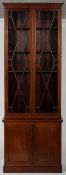 A Georgian style mahogany bookcase on cupboard, with astragal glazing enclosing shelving,