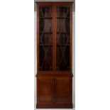 A Georgian style mahogany bookcase on cupboard, with astragal glazing enclosing shelving,