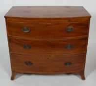 A Regency mahogany cross banded chest of three graduated long drawers beneath a brushing slide,