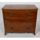 A Regency mahogany cross banded chest of three graduated long drawers beneath a brushing slide,