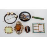A collection of costume brooches and buckles of variable designs.