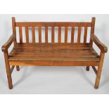 An oak garden bench, with slatted back and seat,