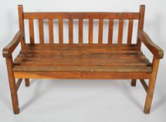 An oak garden bench, with slatted back and seat,