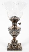 A Victorian silver urn shaped oil lamp and engraved glass lamp, late 19th century,