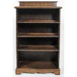 An oak four tier bookcase, circa 1900, with beaded decoration, on plinth,