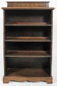 An oak four tier bookcase, circa 1900, with beaded decoration, on plinth,