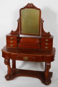 A mahogany Duchess style dressing table, with an arched mirror,