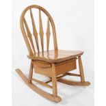 A mid 20th century Ercol beech and elm child's rocker/rocking chair with drawered seat