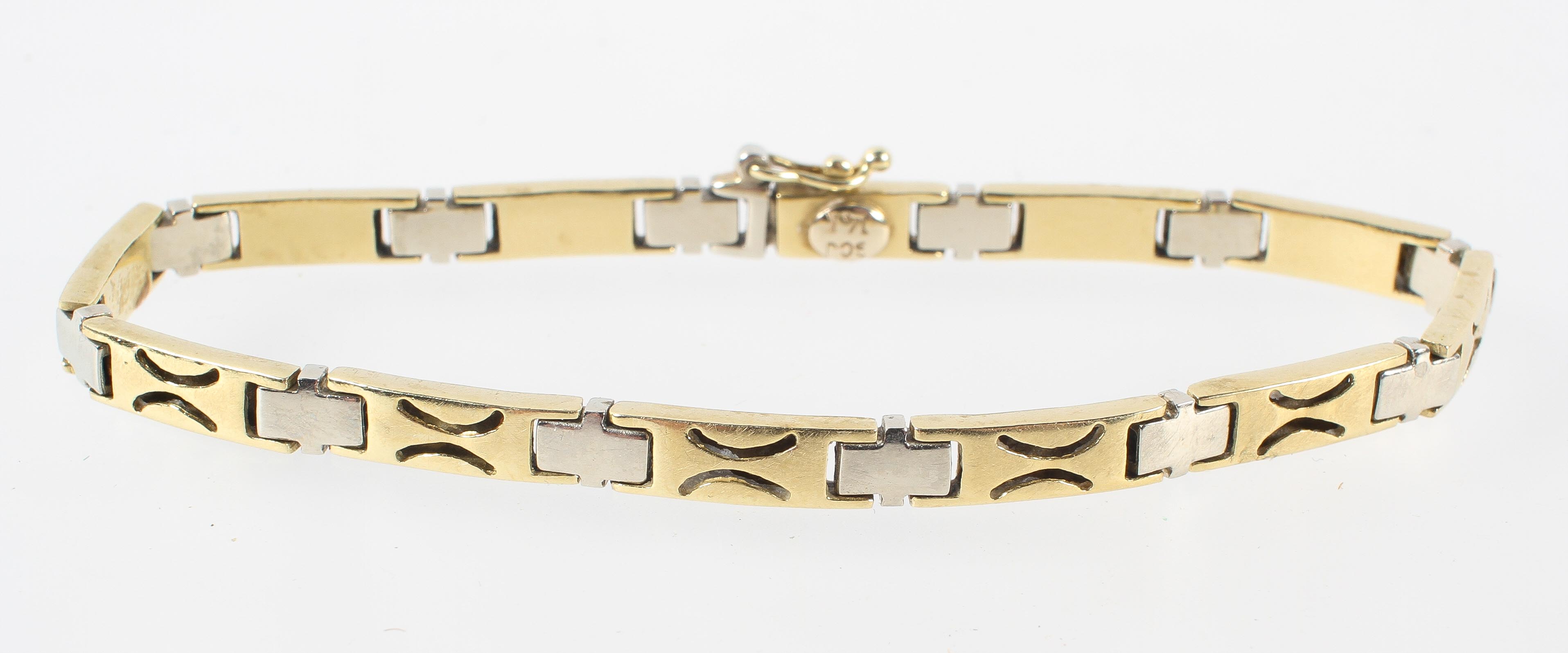 A yellow and white metal linked bracelet. Push in clasp with figure of eight safety catch.