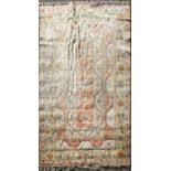 A large wool carpet, decorated with geometric reserves on a coral beige,