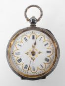 An open face mid size pocket watch. Circular white dial with Roman numerals and gold embellishments.