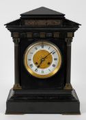 A brass mounted slate mantel clock, the white enamel dial inscribed by Charles Frodsham & Co,