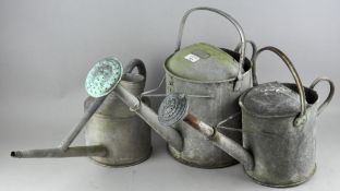 Three galvanized tin watering cans, including two gallon,