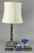 A silver plated column table lamp with shade, together with a Perthshire paperweight,