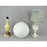 Two carved marble table lamps along with a frosted milk glass globe shade,