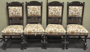A set of four Victorian walnut upholstered chairs, with carved top rails,
