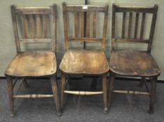 A group of three chapel chairs, each with turned stretcher,