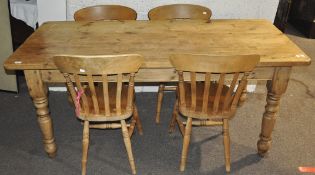 A pine dining table with four matching chairs;