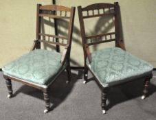 A pair of mahogany nursing chairs, on original ceramic castors,