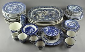 A large collection of 'Willow' pattern ceramics, including five platters,
