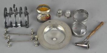 A collection of assorted silver items, including a small four slice toast rack,